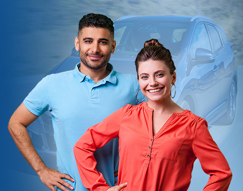 Man and woman standing in front of a car.